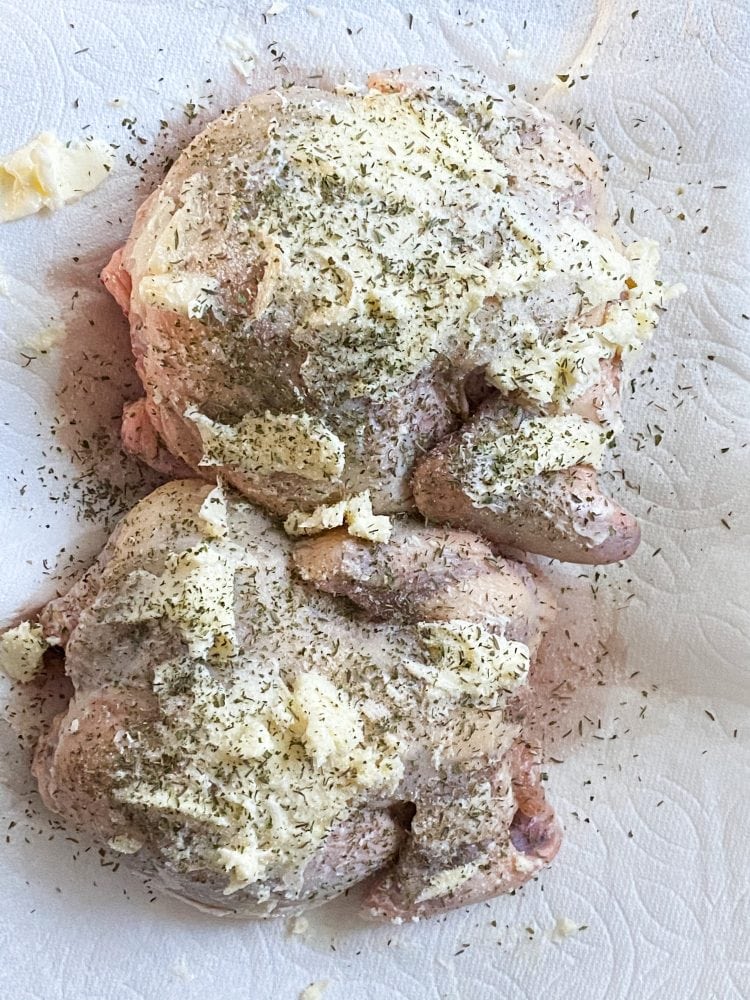 raw cornish game hens on a plate with butter and seasonings