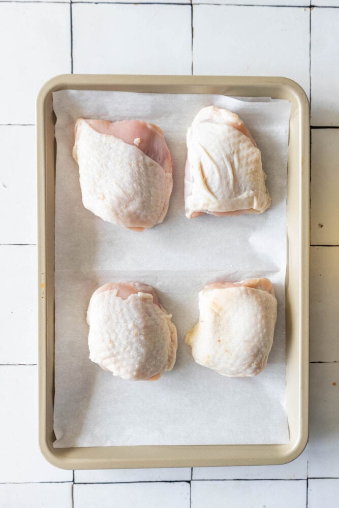 Baked chicken breasts on a tiled floor.
