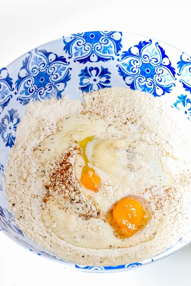 flour, salt, pepper, nutmeg, eggs in a bowl