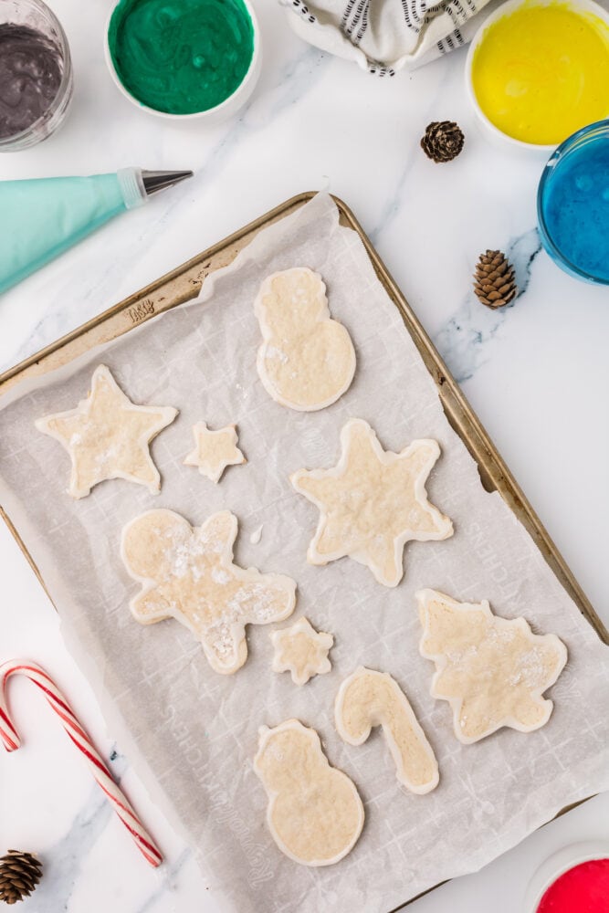 picture of sugar cookies baking on baking sheet lined with parchment paper