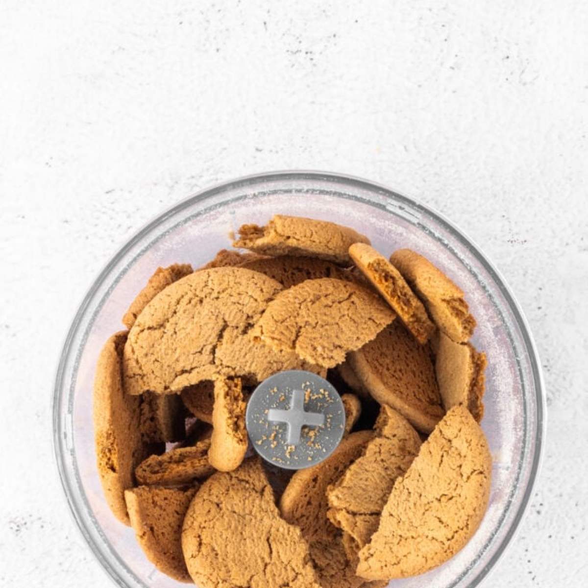 Ginger cookies in a glass bowl on a white background.