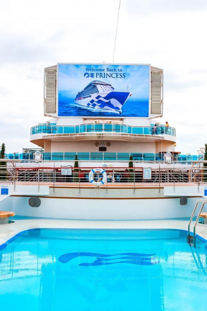 picture of majestic princess tv screen saying welcome back princess above a pool