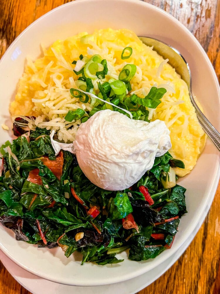 picture of grits, greens, and a poached egg in a bowl 