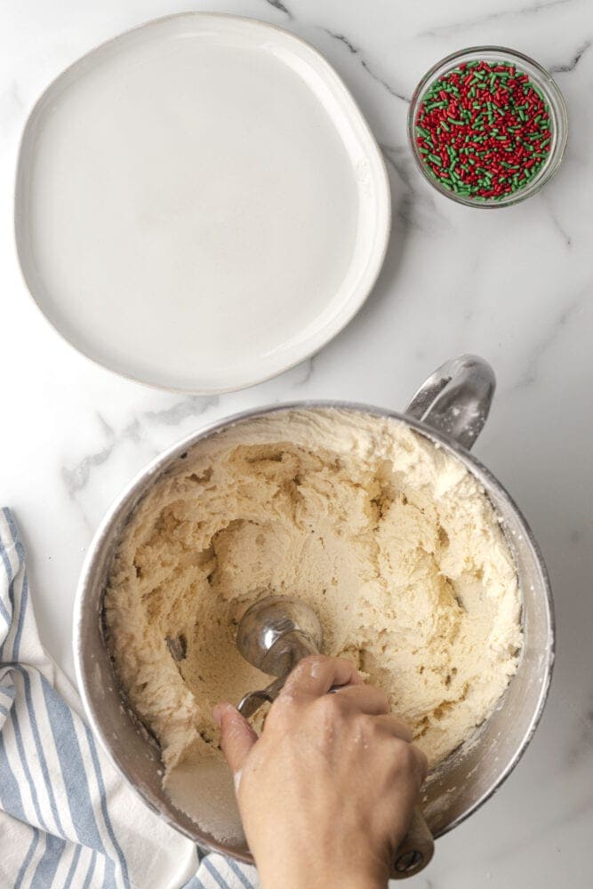 picture of hand scooping cookie dough 