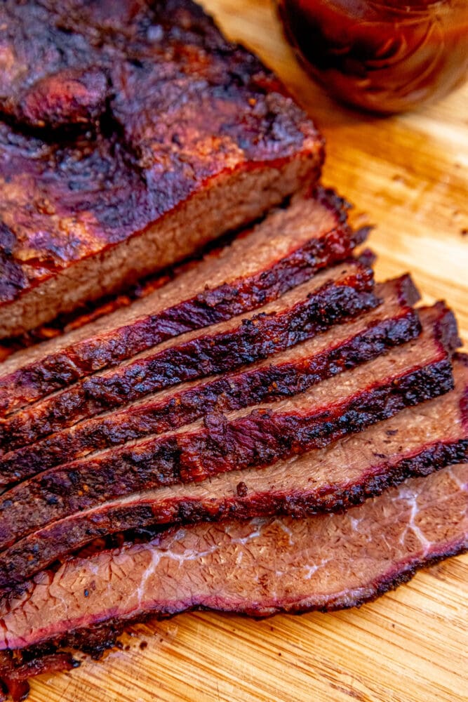 sliced smoked brisket on a wood cutting board