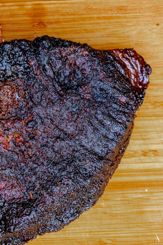 whole smoked brisket on a cutting board