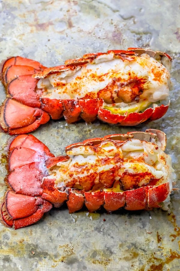 broiled lobster tails on a baking sheet