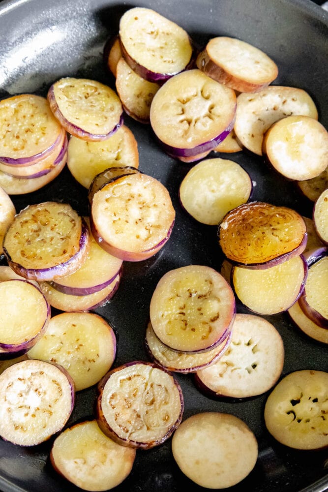 sliced eggplant in a pan frying