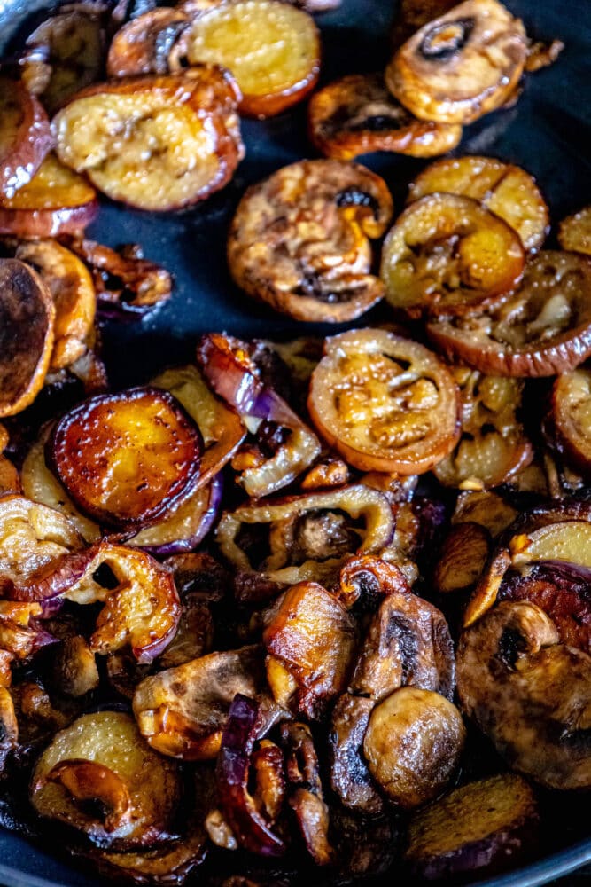 fried eggplant and mushrooms in a pan