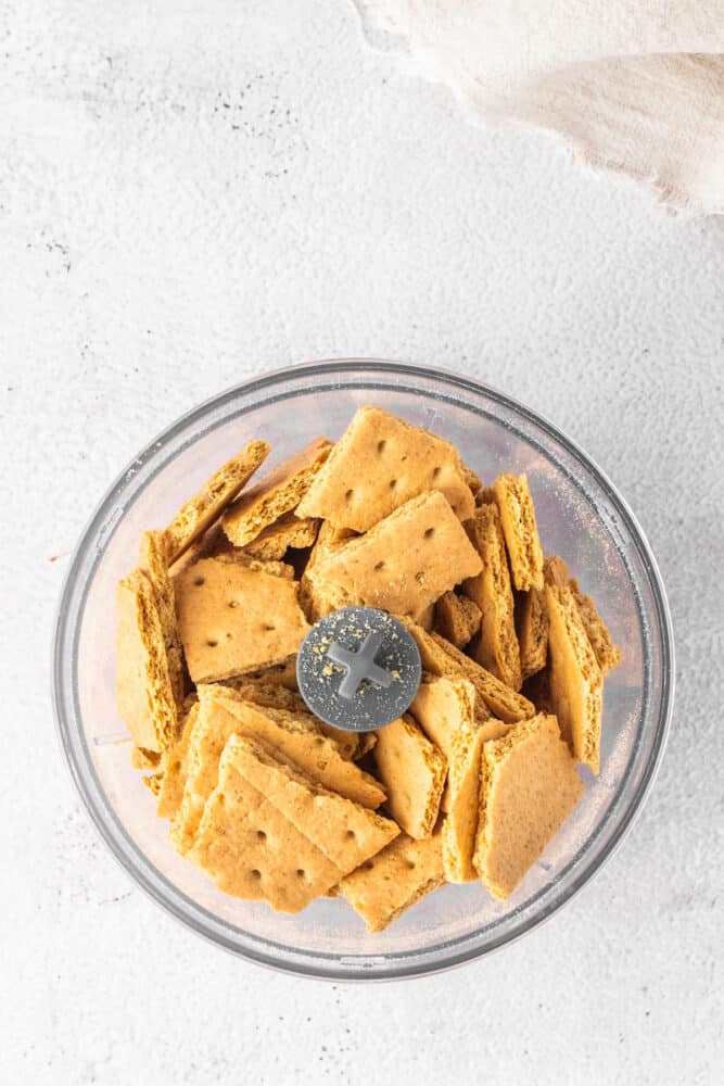 Crackers in a glass bowl on a white background.