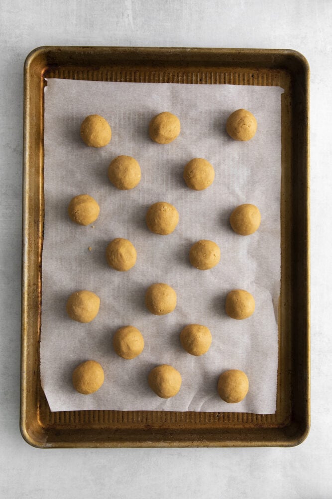 picture of peanut butter truffles rolled out on a baking sheet lined with parchment paper